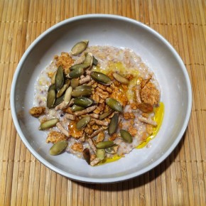 basic oatmeal topped with granola, pumpkin seeds and flax seed oil